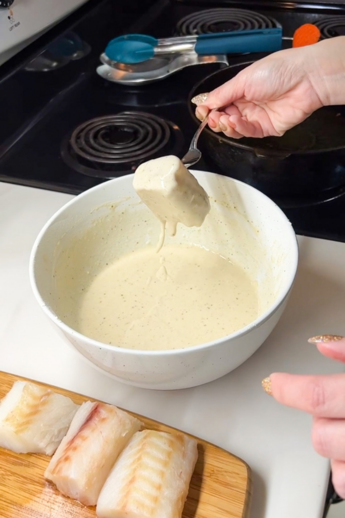 Fish coated in thick beer batter showing proper frying consistency