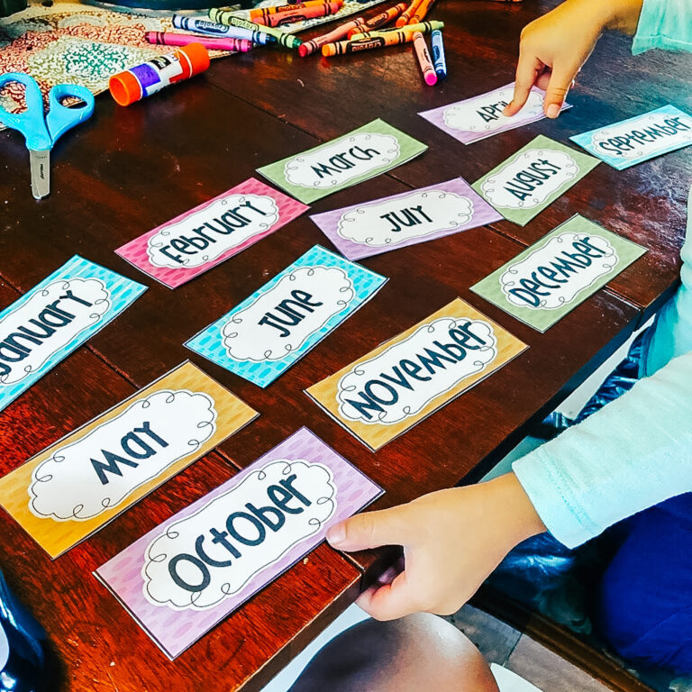 One of my daughters pointing and saying the months of the year from cards I printed from Teachers Pay Teachers
