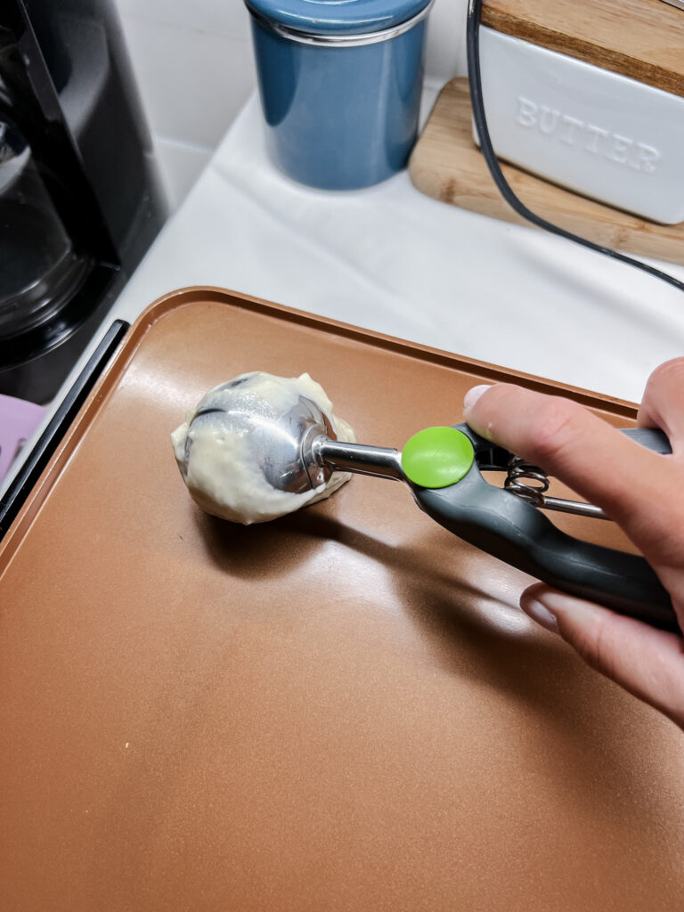 putting batter on the griddle with the cookie scoop