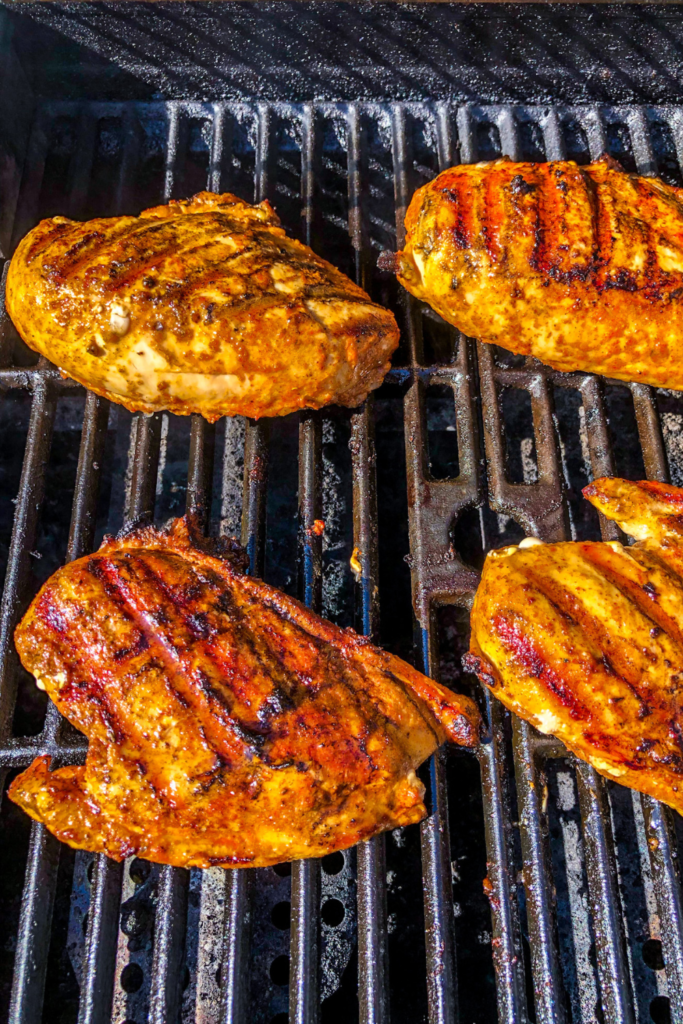 Chicken on the grill; after being flipped once.