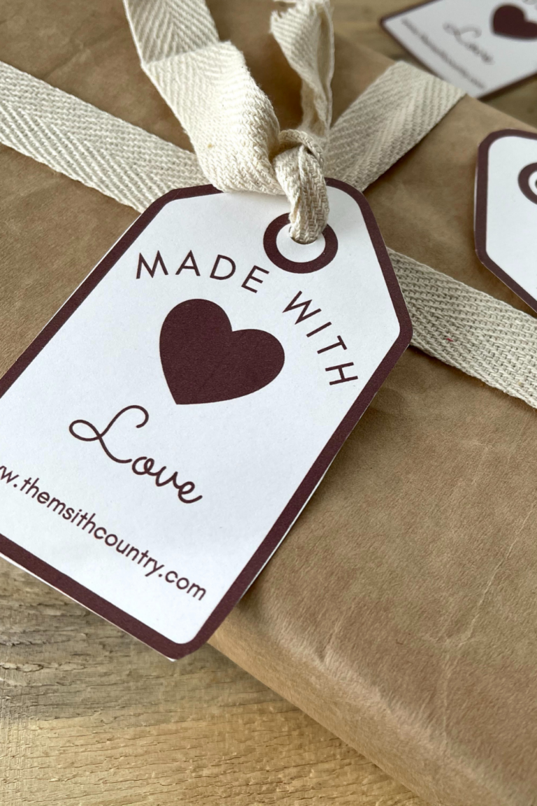 Made with love tags (free version) being displayed as the would be used. One is tied to a brown paper wrapped package and others are laying around.