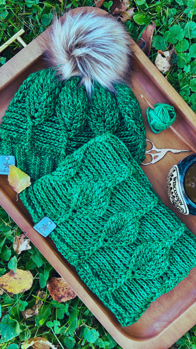 image of a matching Birch Leaf Cowl and Beanie on a wood tray with a cup of coffee