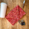 Then purse with a cup, keys, and lip gloss laying around in a flat lay.
