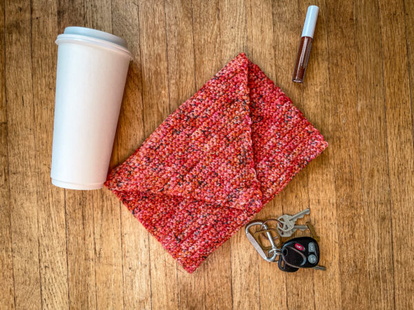 Then purse with a cup, keys, and lip gloss laying around in a flat lay.