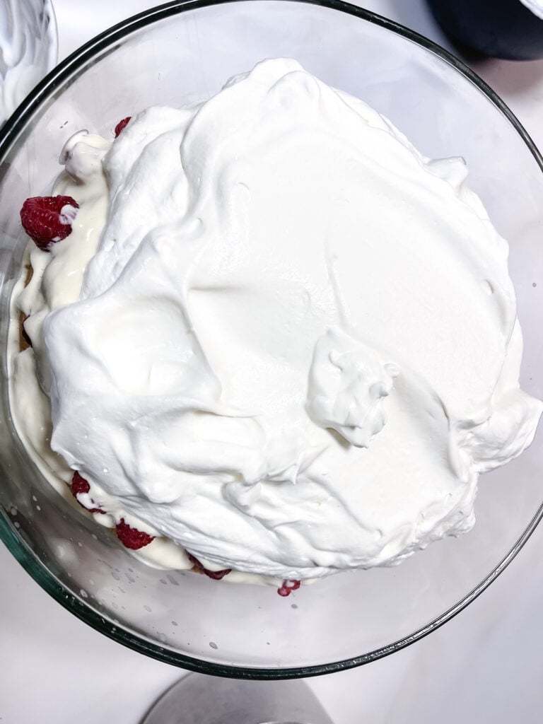 final whipped cream layer on raspberries