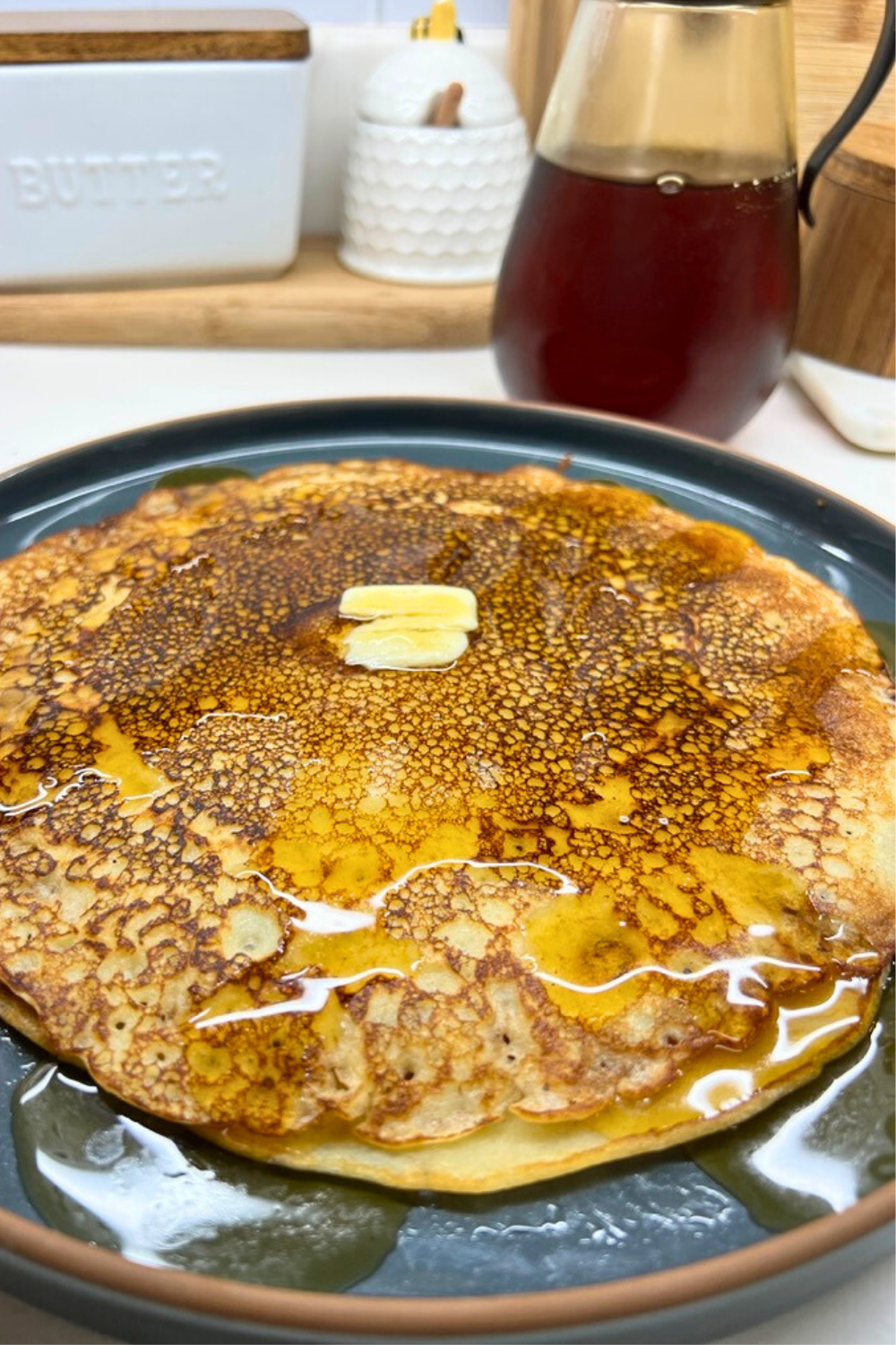 Photo, Prop Styling, and Food Styling by Jenn Smith pancakes on a blue plate with syrup and butter