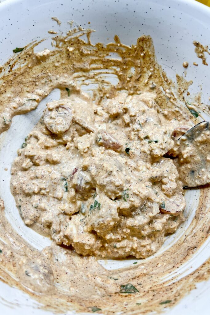 dressing being mixed after cheese added
