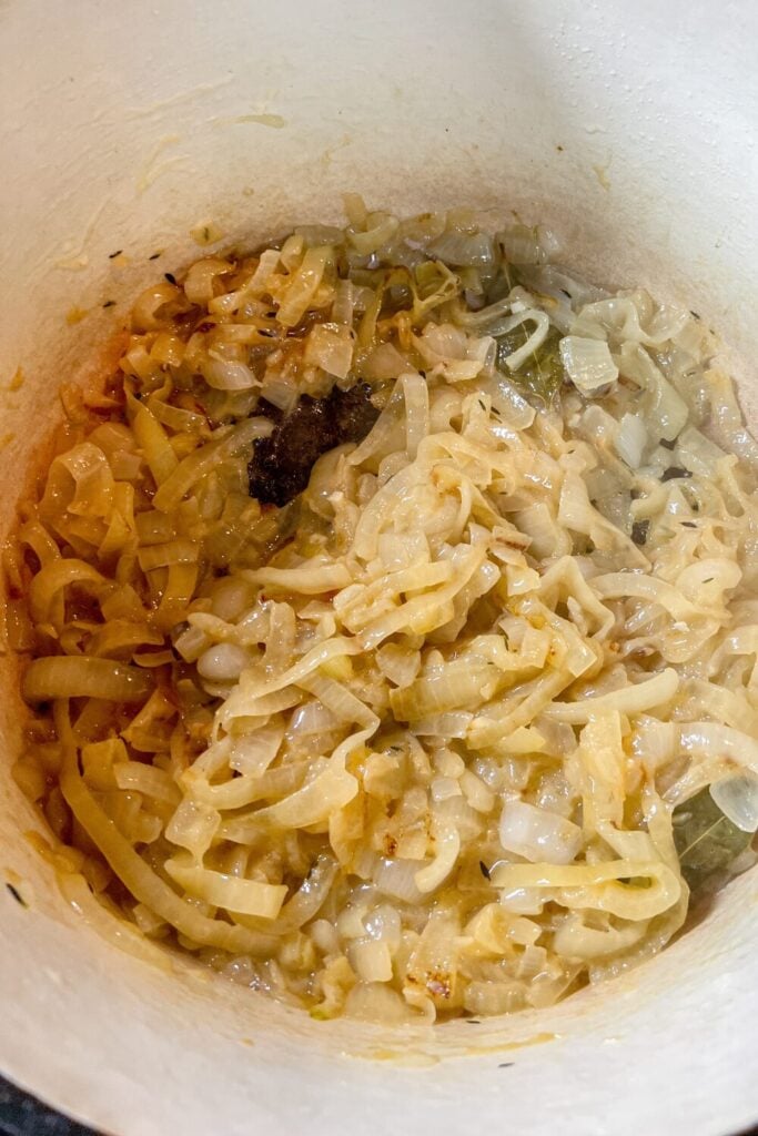 cooked sliced onions, chopped garlic, and thyme, in a cast iron pot on the stove 2