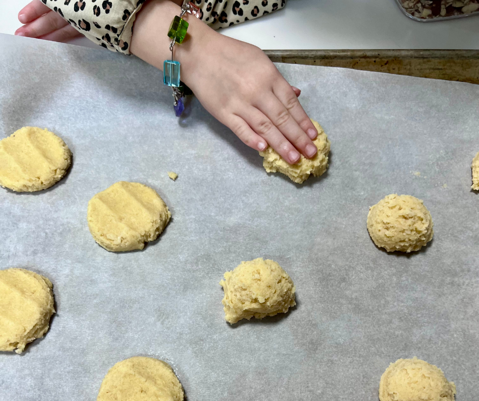 kid hands pushing a cookie down