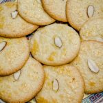 Chinese Almond Cookies laying on a plate in a layered circle.