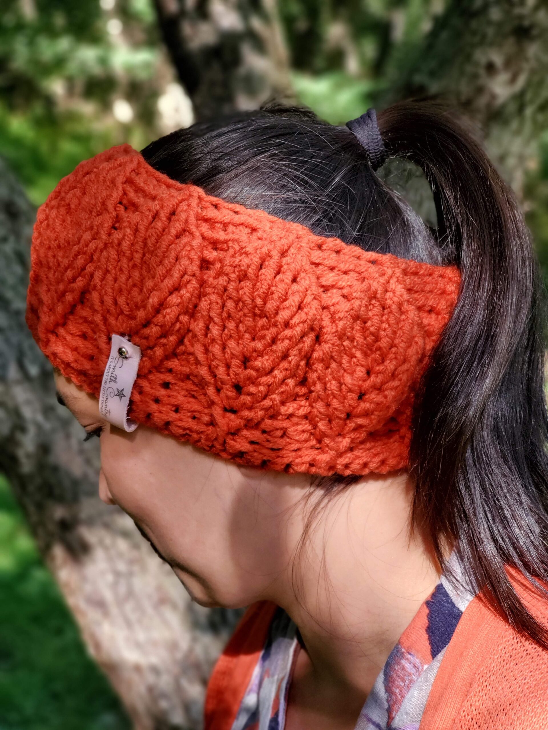 Birch Leaf ear Warmer being warn by a brunette with a pony tail.