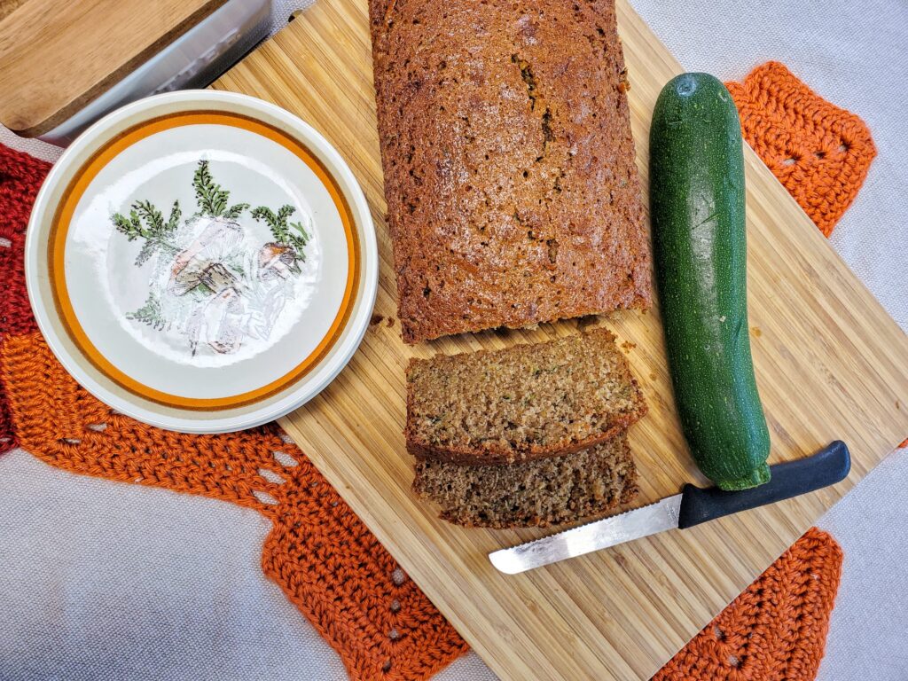 Zucchini Bread served on a bamboo cutting board with mushroom plates.