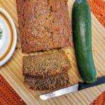 Zucchini Bread served on a bamboo cutting board with mushroom plates.