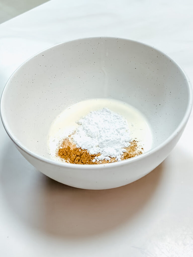 Cinnamon Whipped Cream Ingredients sitting in a ceramic mixing bowl by Mora Ceramics