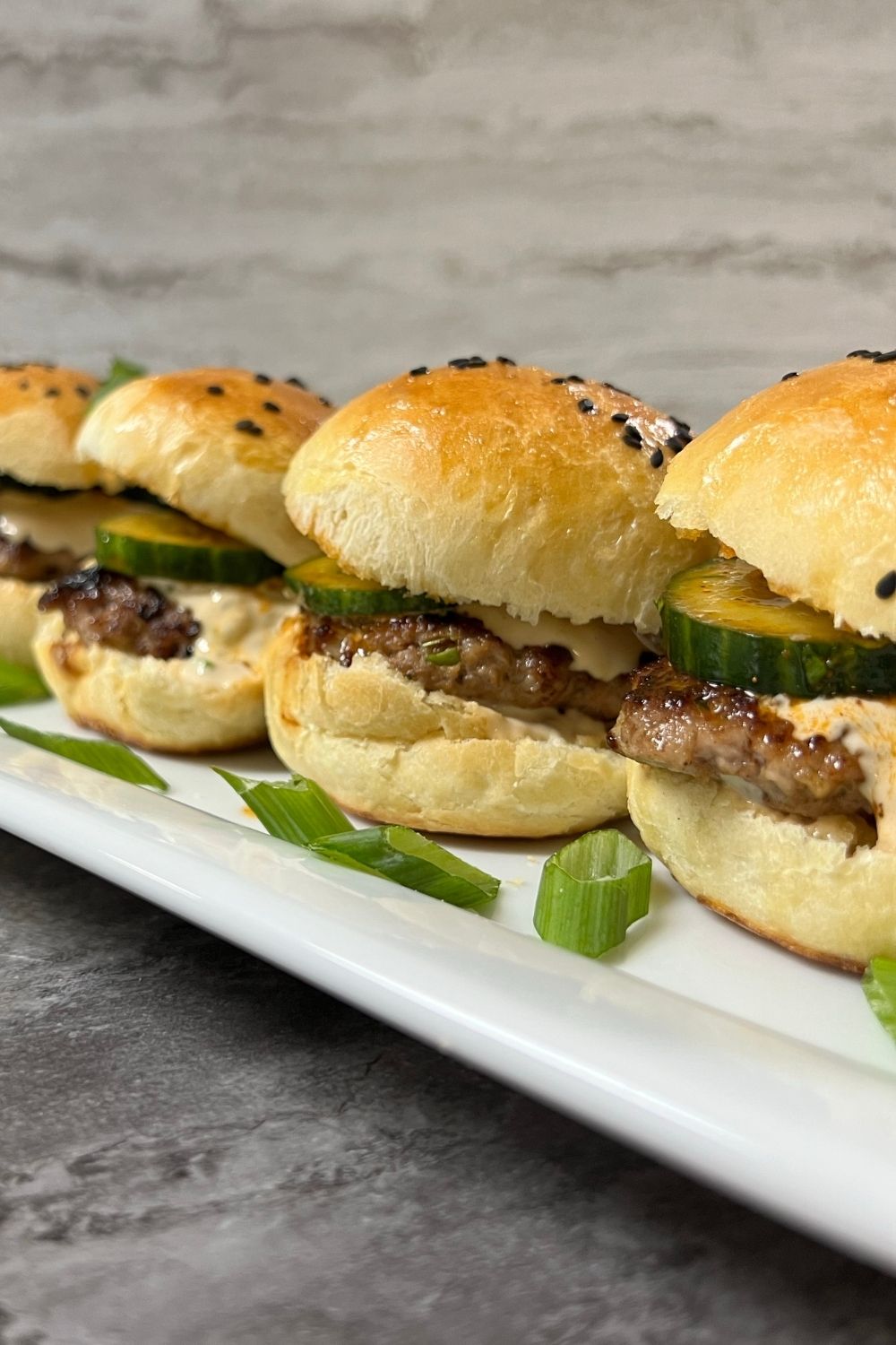 Wonton Burgers in little slider size on a white platter.