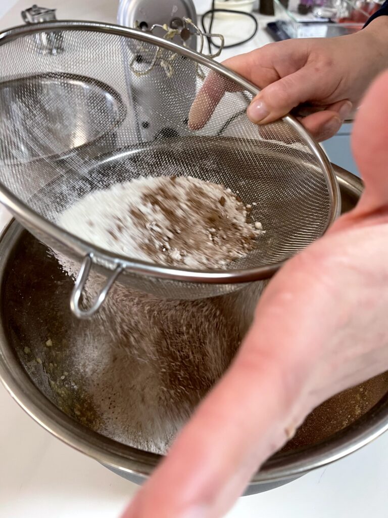 shaking dry ingredients into bowl.