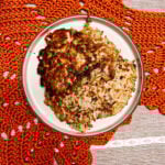 scallion potato pancakes on a ceramic plate sitting on a crocheted runner.