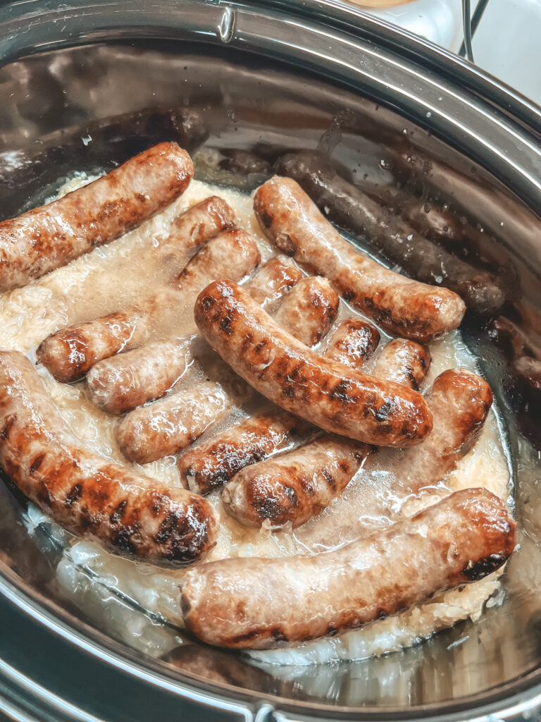 Brats in sauerkraut in a slow cooker