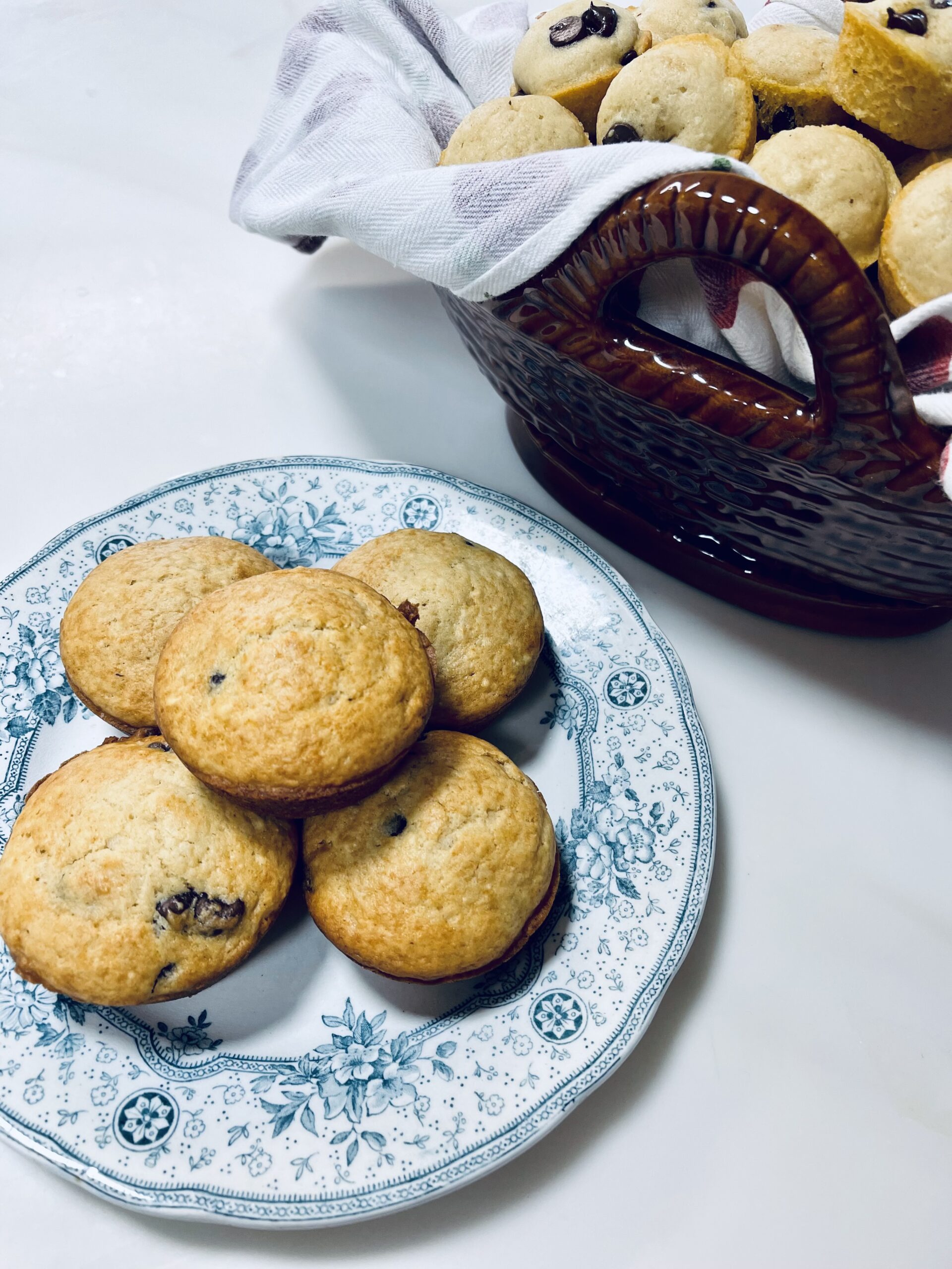 Image of chocolate chip muffins on an an old blue plate.
