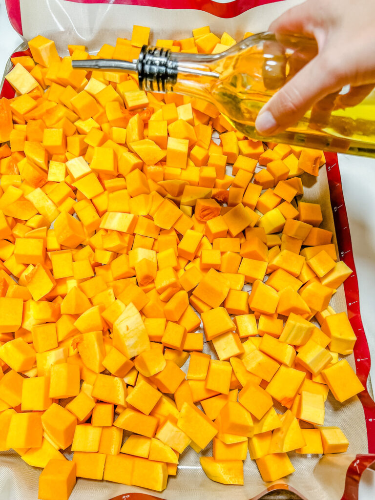 Squash getting drizzled with olive oil.