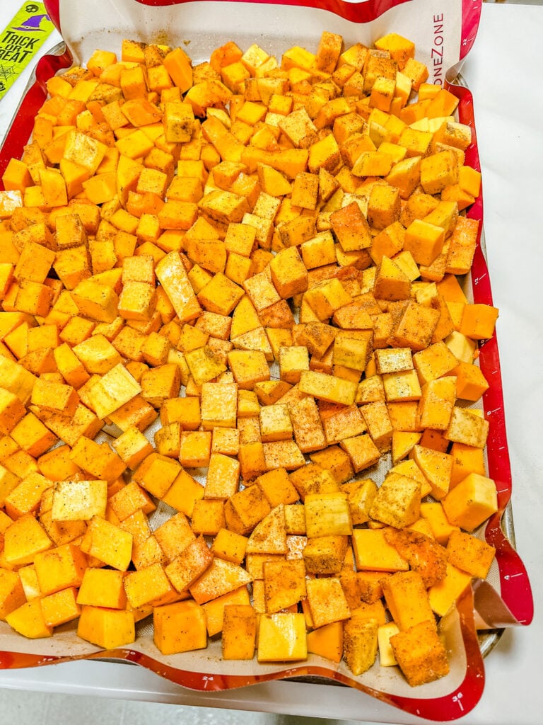squash in a baking sheet with spices coated, just before baking.