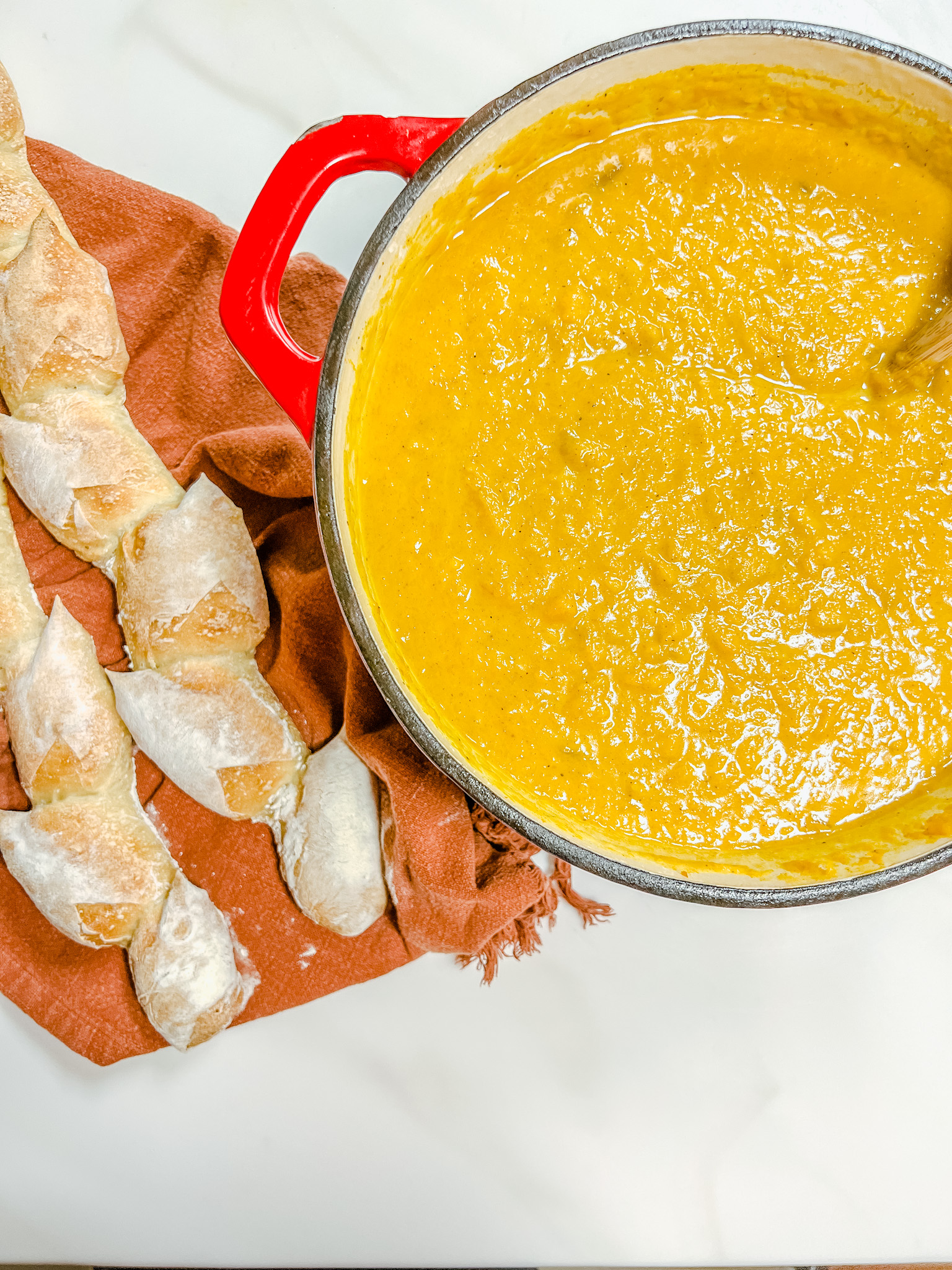 Butternut squash soup in a lodge dutch oven, and bread on the side.