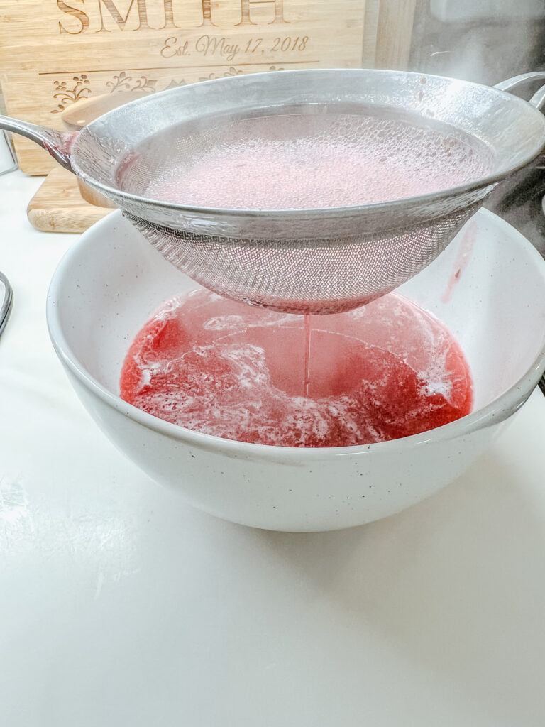 finishing draining the cranberry purée