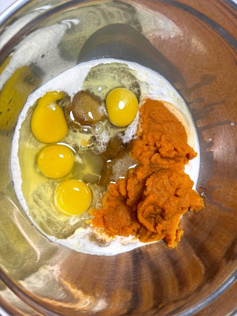 eggs, sugar, pumpkin, and milk before being mixed.