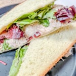 Close up of the Chicken Salad Sandwich cut in half so you can see the salad and lettuce.