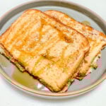 French toast finished set in a stack on a ceramic gray plate