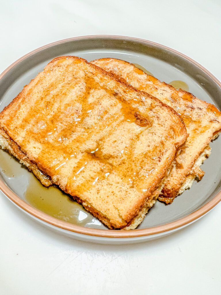 French toast finished set in a stack on a ceramic gray plate