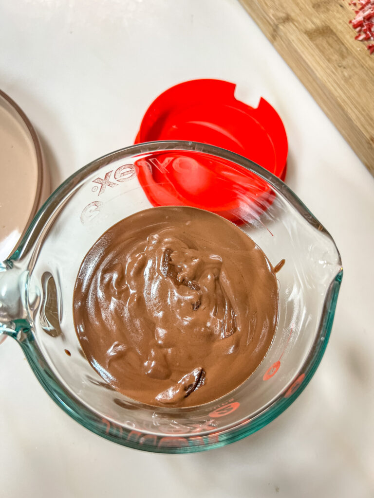 Chocolate in a microwave safe measuring cup, with a pour spout.