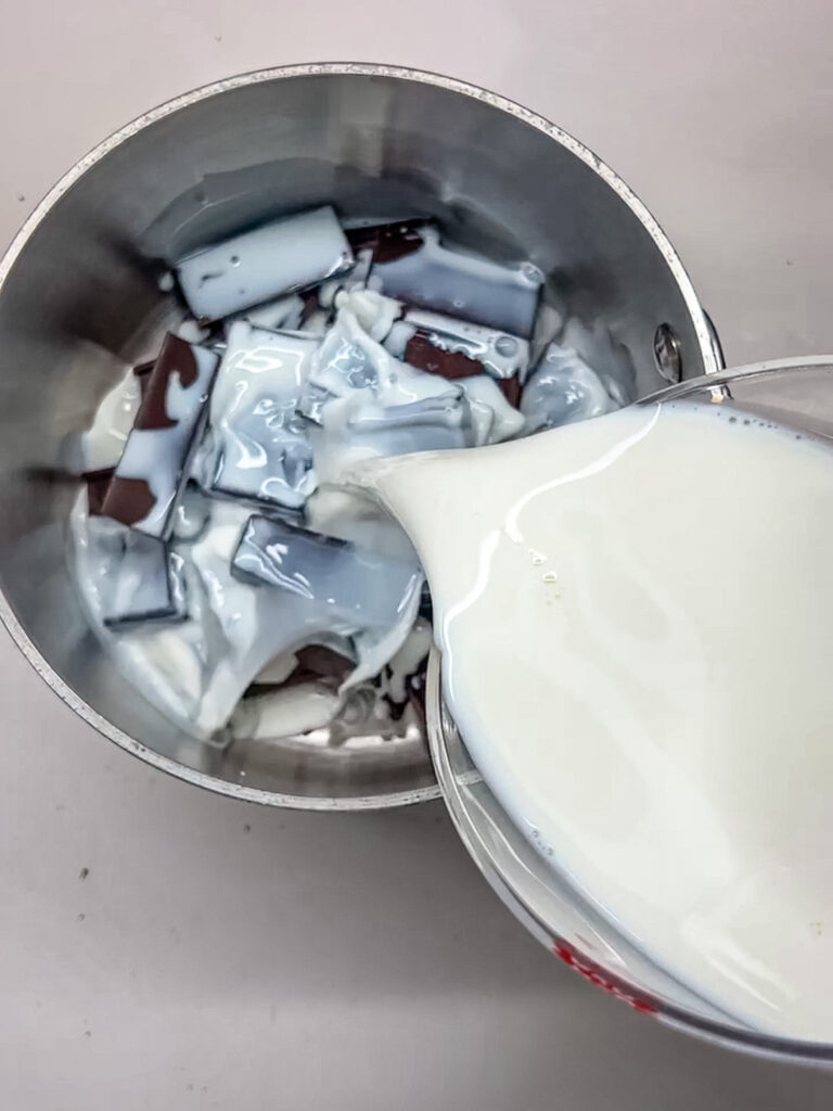 milk being added to the chocolate pieces