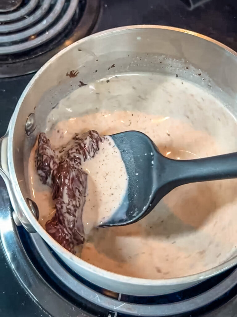 using a heat safe spautla showing how the chocolate is beginning to melt.