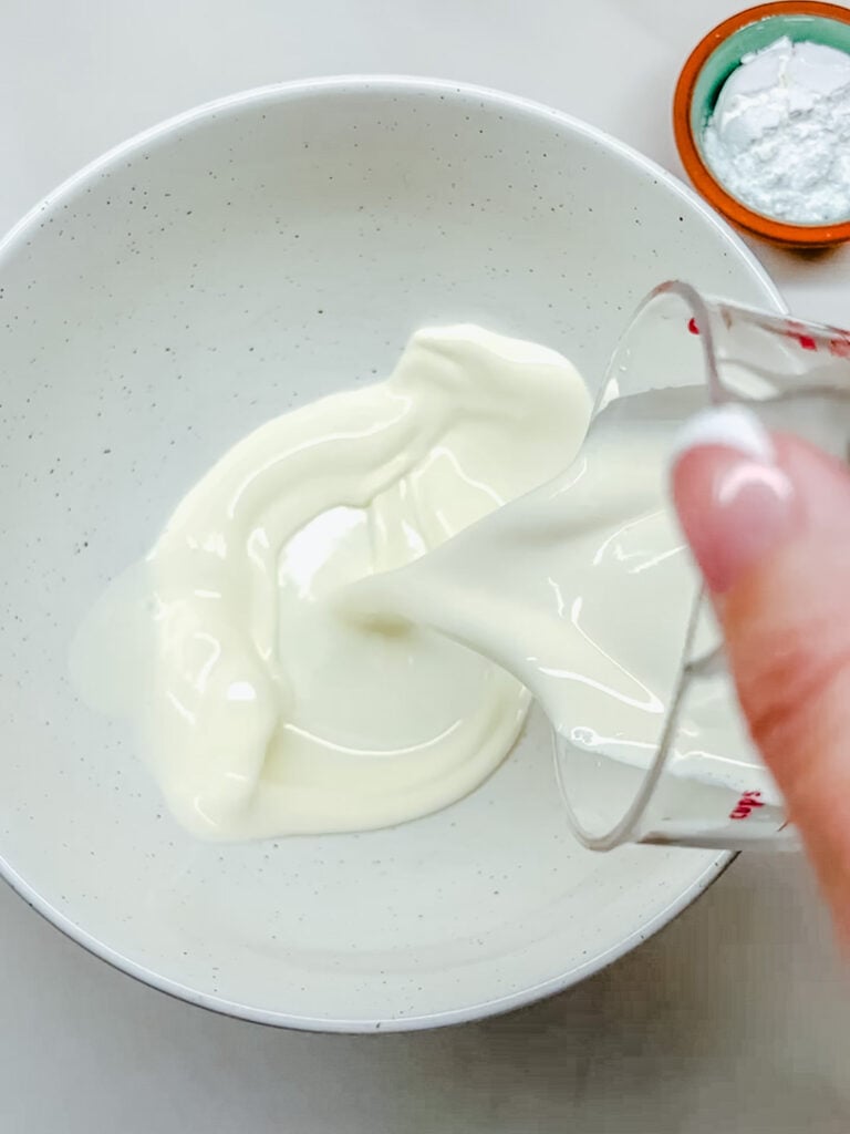 Heavy cream being poured into a cold bowl.