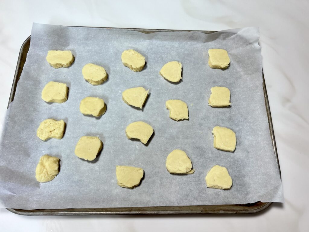 Chinese Almond cookie dough discs on a baking sheet ready to bake.