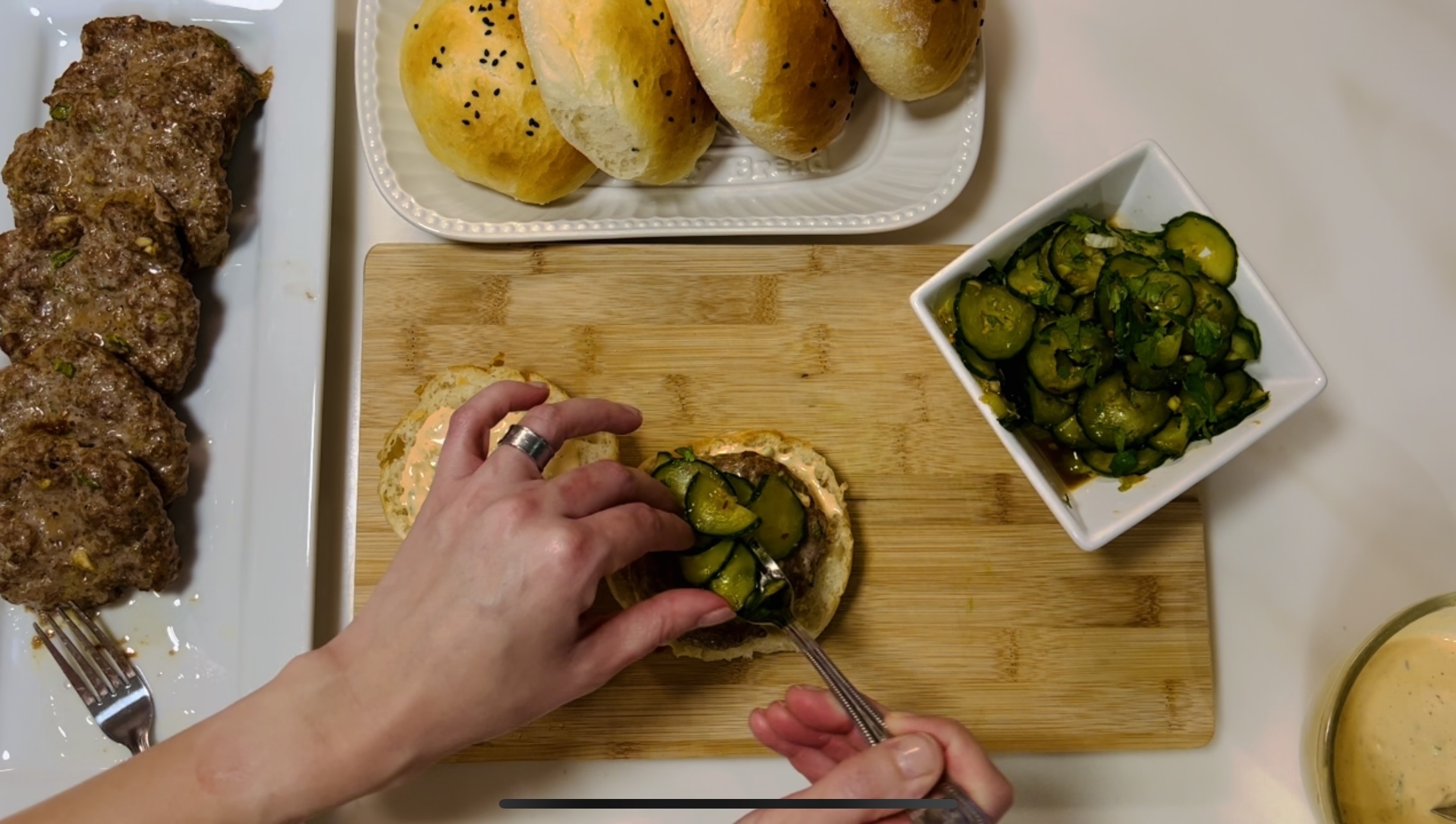 Asian Cucumber Salad on top Of the Pork Burger