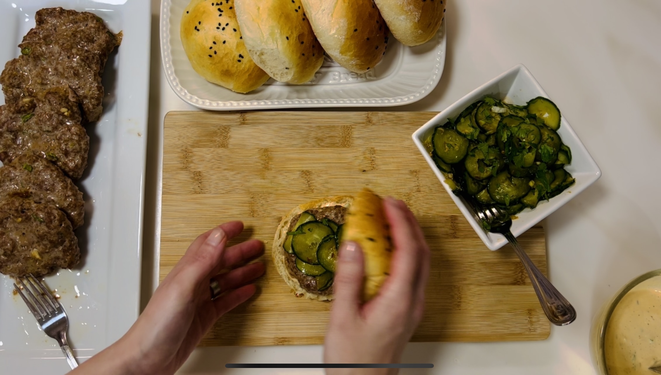 topping the burger with the top of the burger bun.