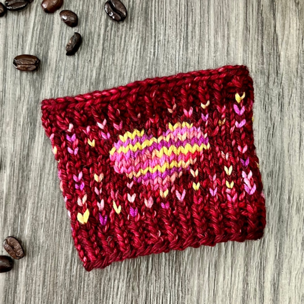 Finished cup sleeve in a flat lay. coffee beans laying around.