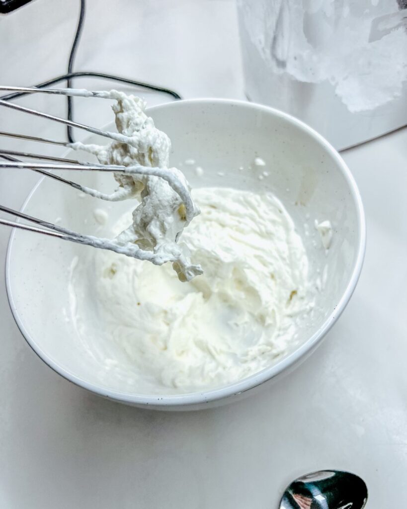 Whipped Cream finished by a hand mixer. whipped cream still on the beaters.