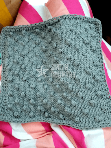 finished bubble washcloth laying on my lap.