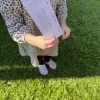 a Younger child holding one of the tickets in their hand.