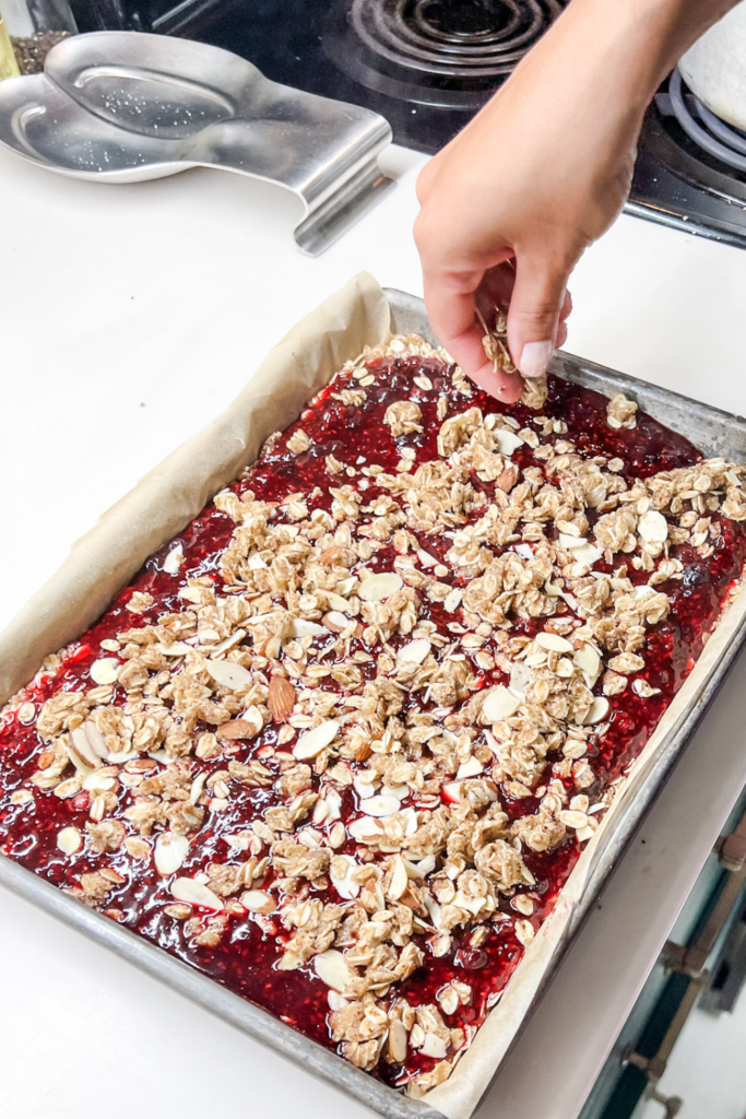 me finishing putting the topping on top of the hot berry filling.