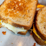 Close up of 2 Finished Grilled Cheeses on the sheet pan.