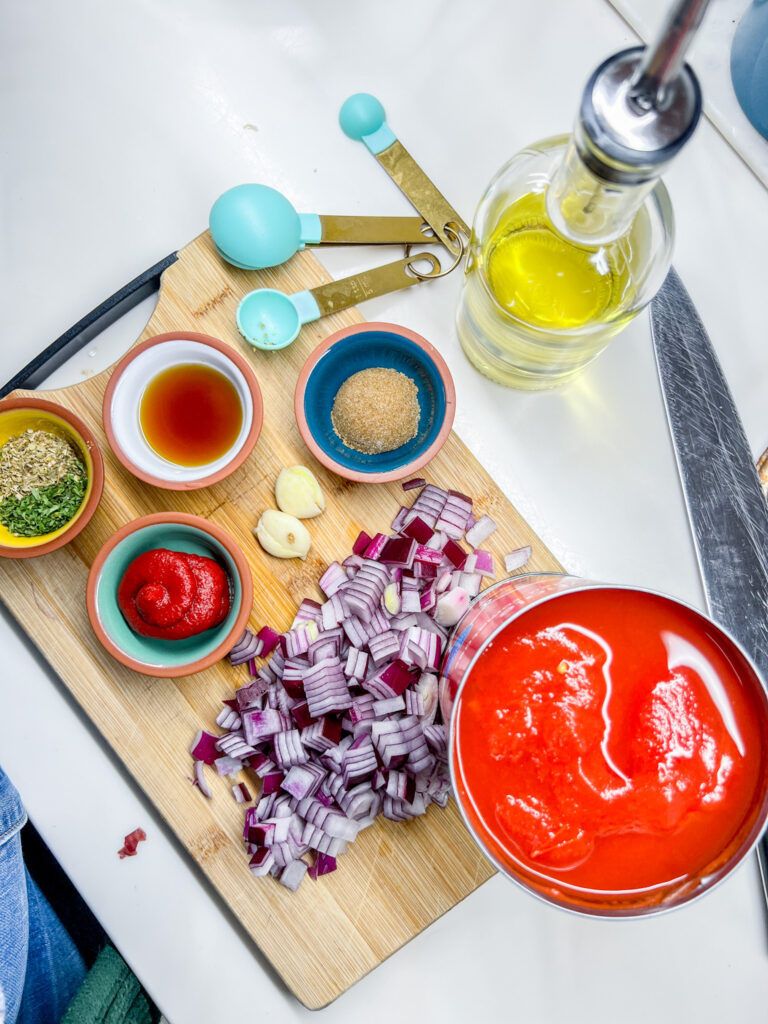 Marinara Sauce ingredients on a cutting board.