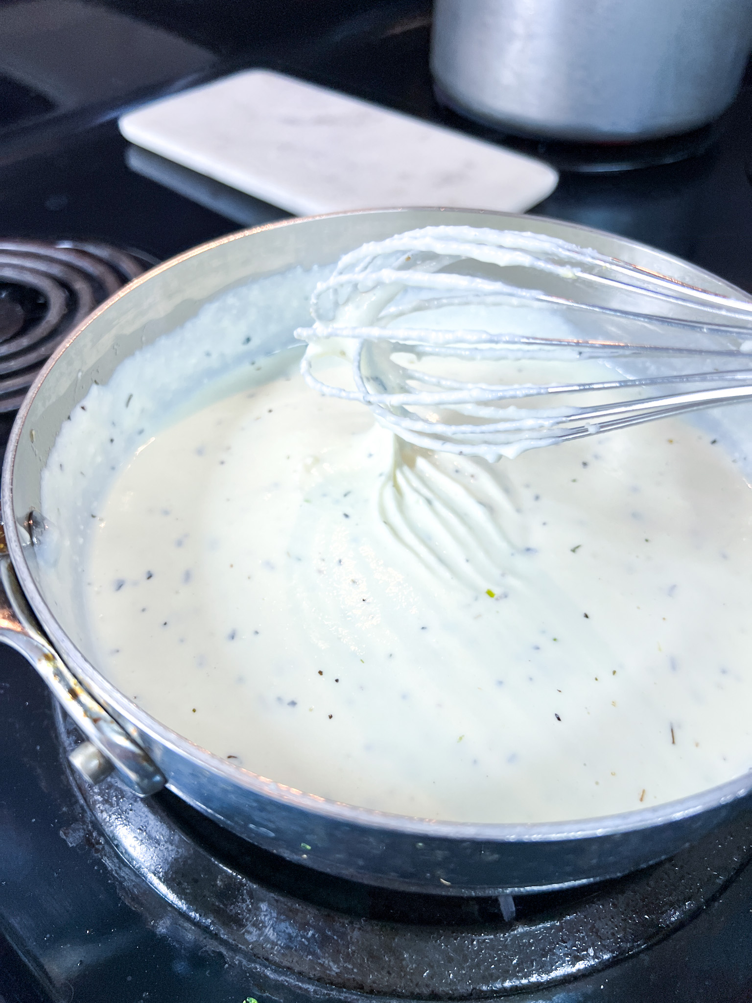 image #4 image of the ricotta "melted" and a whisk showing the thickness.