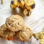mini banana muffins on a marble platter with bananas