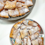 finished beignets on a gray platter