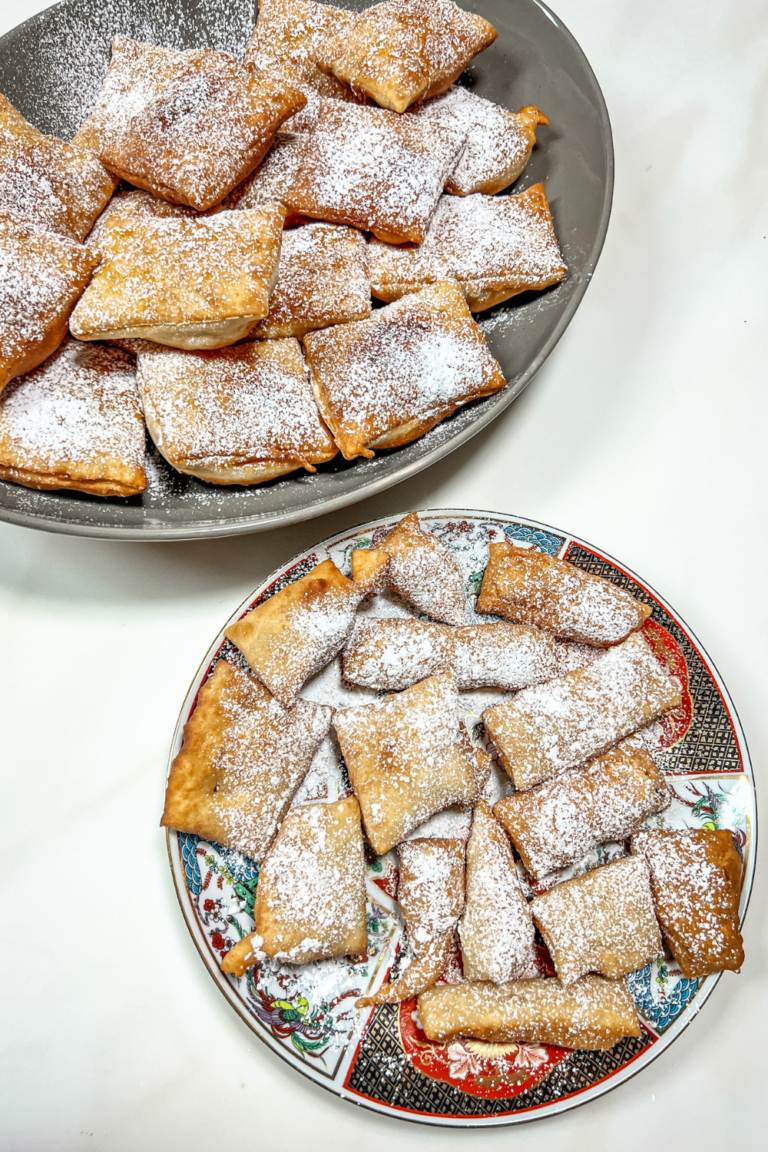 finished beignets on a gray platter