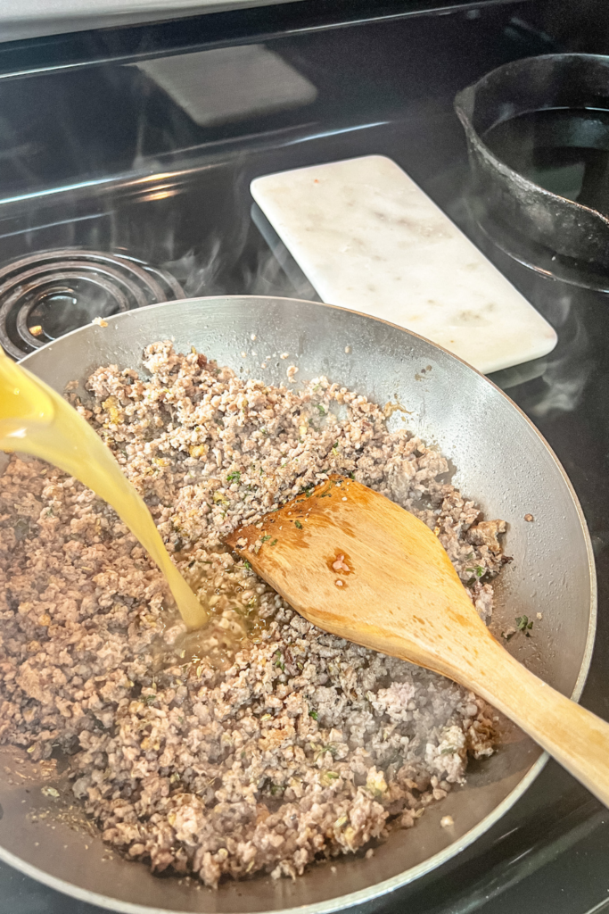 One-Pot Rigatoni Ragu - adding broth to spices and meat